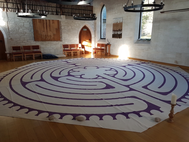 Circular labyrinth painted on fabric, positioned on Othona chapel floor