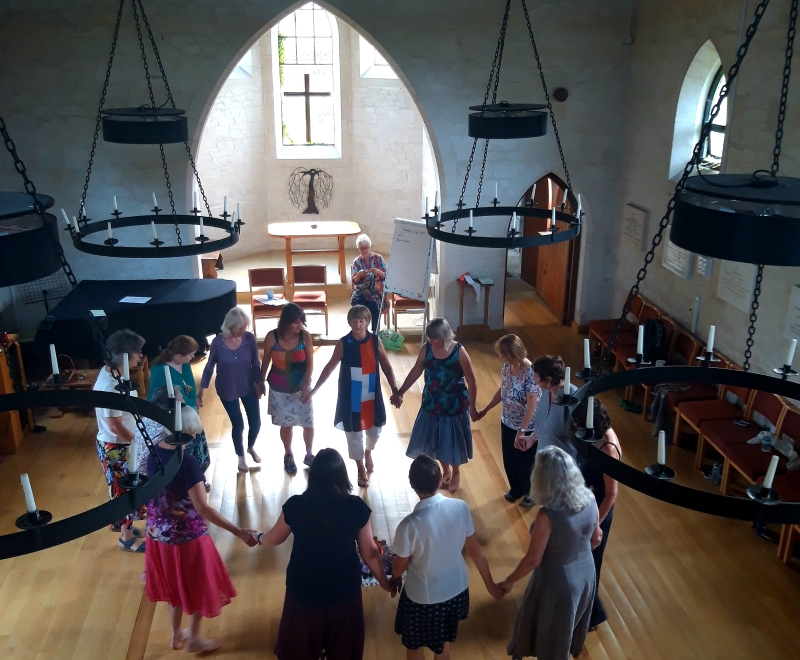 Group circle dancing in Othona chapel, view from the gallery