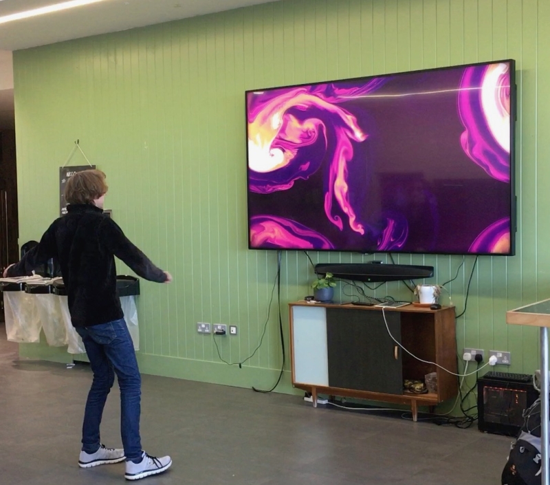 George Corney and his fluid movement art on a large screen