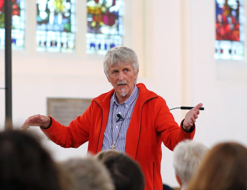 John Bell speaking to an audience
