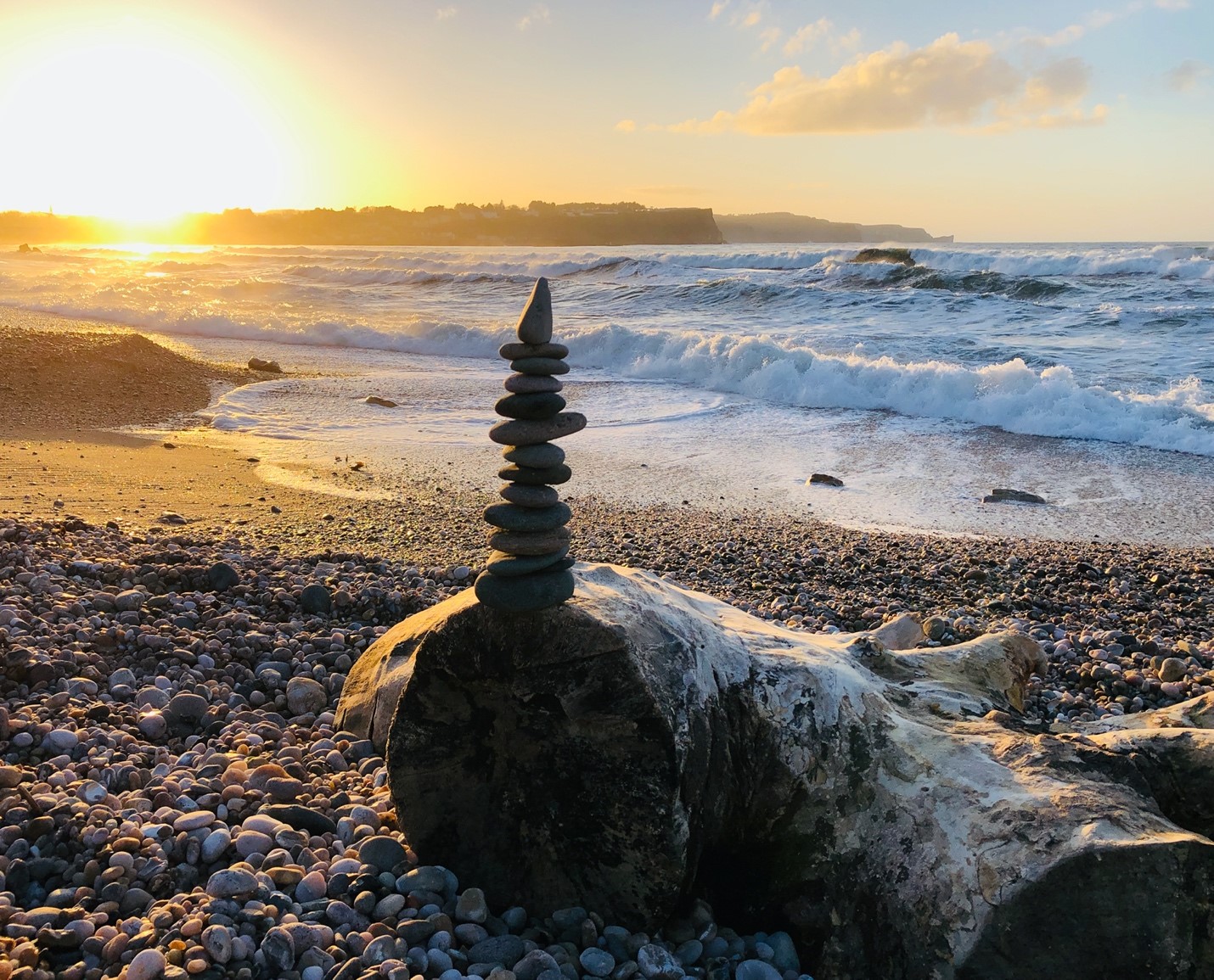 Stones piled artistically on sunset beach