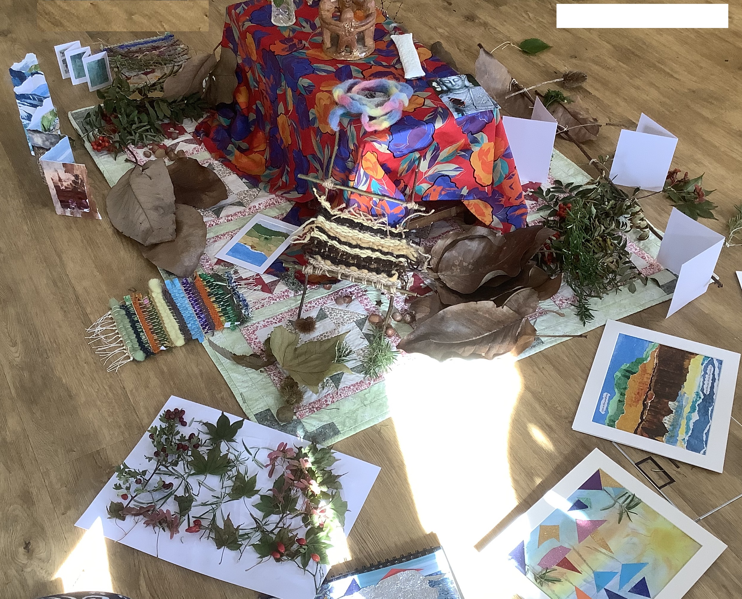 Varied art and craft pieces arranged on studio floor