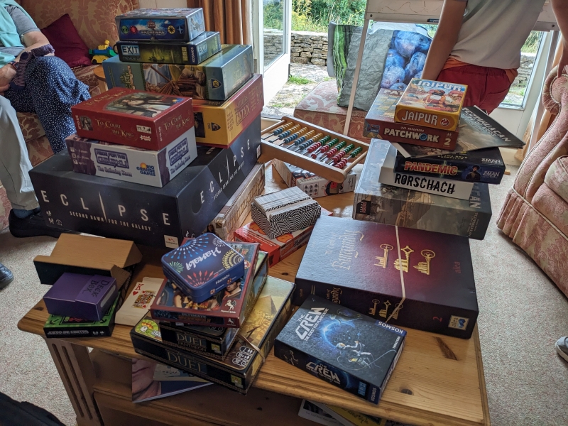 Heaps of board game boxes in the Othona sitting room