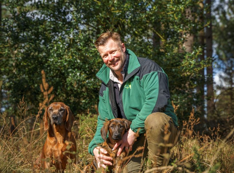 Wildlife ranger Mark Warn with two dogs