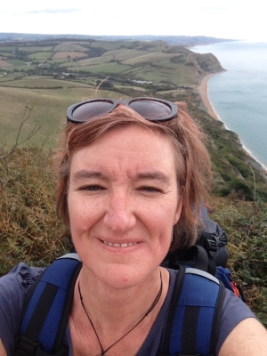 Rosie Miles head and shoulders with coastal landscape in background